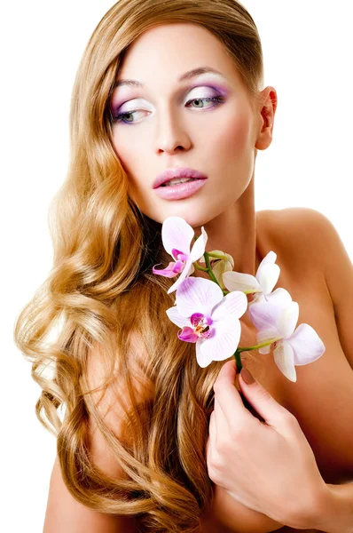 Long-haired blonde with pink orchids — Stock Photo, Image