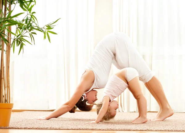 Anne ve kızı yoga egzersizleri yapıyor