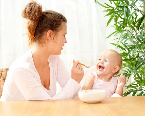 Mother feeding her baby Stock Picture