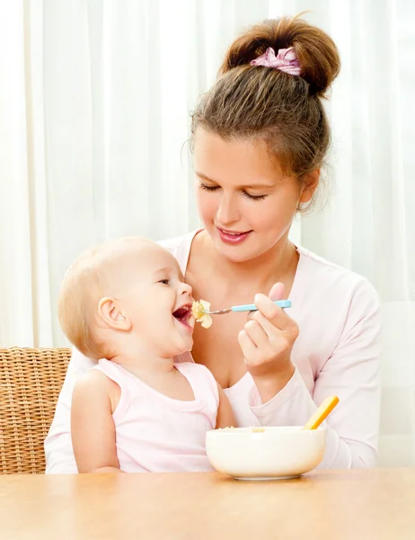 Mother feeding her baby Royalty Free Stock Photos