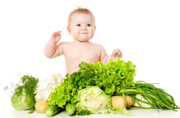 Bebê engraçado com legumes — Fotografia de Stock