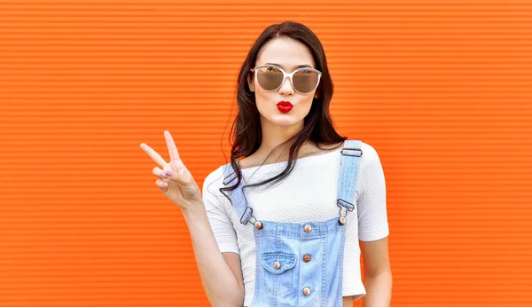 Beautiful Brunette Woman Sunglasses Blowing Lips Kiss Orange Background Outdoors — Stock Photo, Image