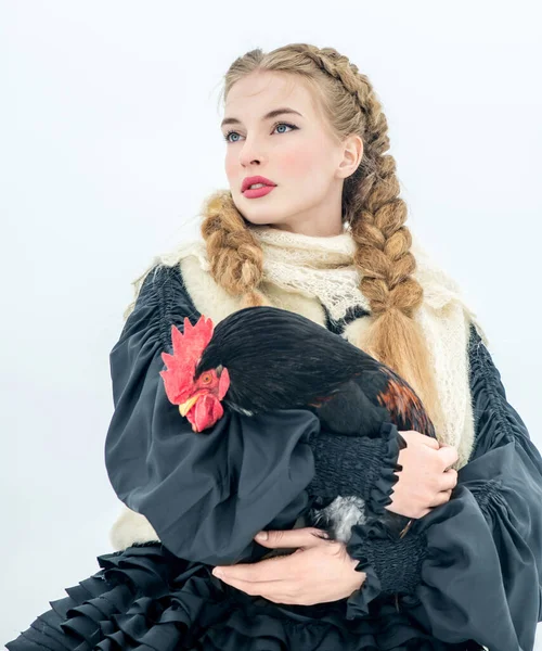 Beautiful Russian woman in a traditional dress. Russian village. Winter.