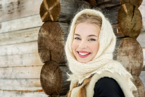 Beautiful Russian woman in a traditional dress. Russian village. Winter.