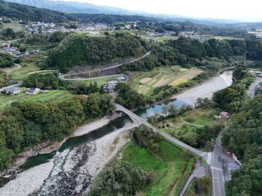 A beautiful landscape with a river and a bridge. The bridge is over a river and the view is very scenic