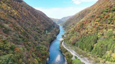 Renkli dağlarla çevrili nehrin havadan görünüşü