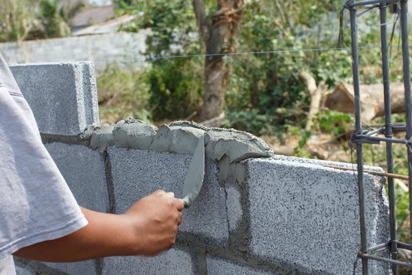 Workers build a wall detail