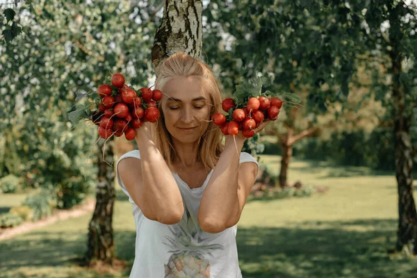 Uma Menina Sorrindo Segura Enorme Rabanete Rosa Suas Mãos Contra — Fotografia de Stock