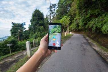  Pokemon Go yükleme bir cep telefonu tutan el
