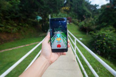  Pokemon Go yükleme bir cep telefonu tutan el