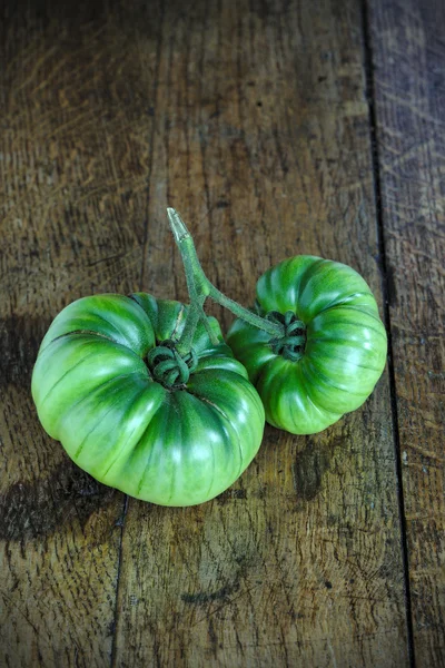 Green Black Krim tomato on a wooden farm table