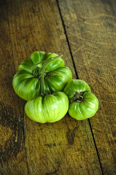 Green Black Krim tomatoes on a wooden farm table 1