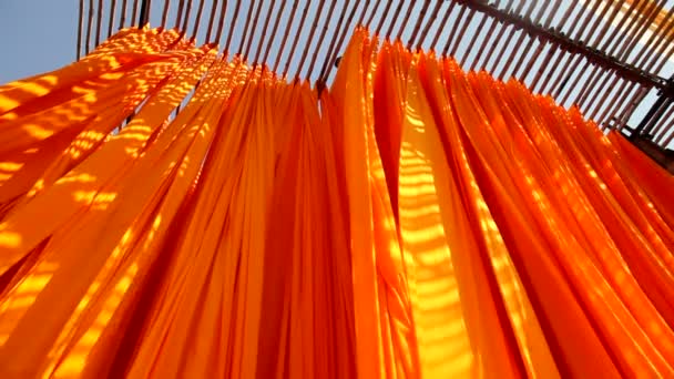 Dyed fabric hanging from Bamboo poles — Stock Video