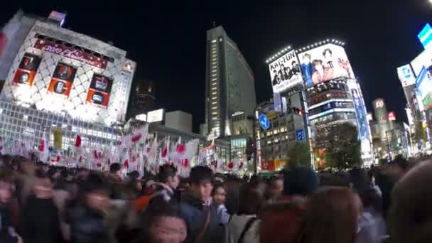 Pedestrians and traffic across Shibuya Crossing — Stock Video