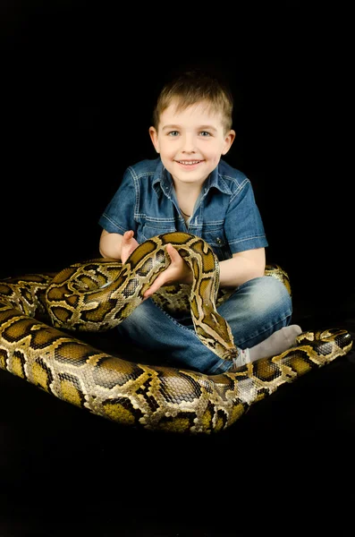 Счастливый ребенок и гигантская змея — стоковое фото