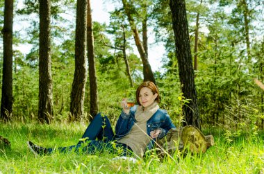 Yalnız kız ormanın içinde yeşil çay keyfi