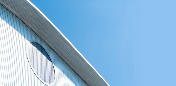 Factory Warehouse roof with blue sky light, White industrial estate background with copy space