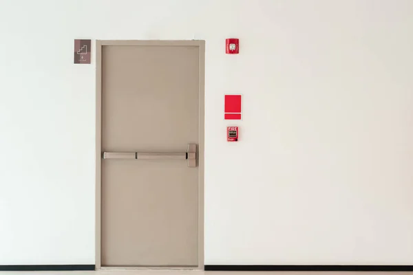 Fire exit door background with copy space wall, interior office building