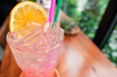 Kırmızı punçlu soda bardakta turuncu silce, yaz mevsimi için kafede renkli soğuk ferahlatıcı içecek.