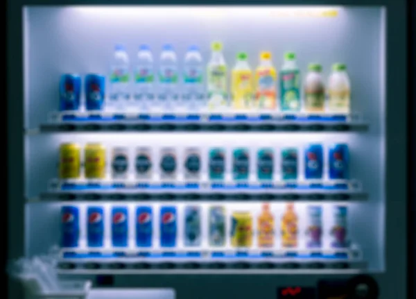 Blurred Vending Machine with Colorful Soft Drink, Coffee, Juice and Water Bottle Background, Easy and Convenience Modern Auto Beverage Dispenser at Night Time