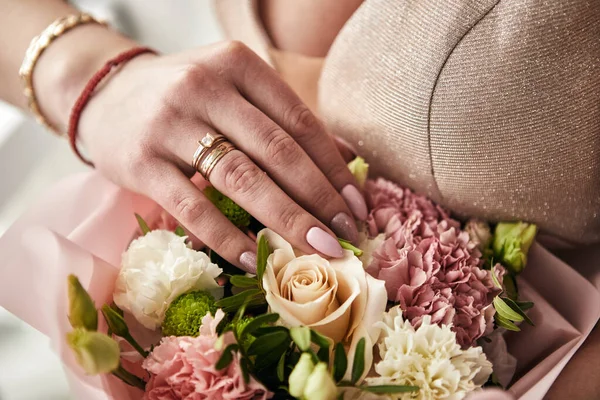 bouquet in hands of the bride, woman getting ready before wedding ceremony