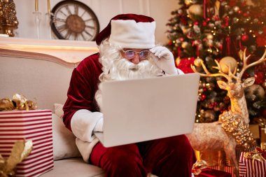 Noel Baba evinde oturuyor ve dizüstü bilgisayarında Noel 'le e-posta okuyor. Şöminenin yanında bir dilek listesi ve hediyeli bir ağaç istiyor. Yeni yıl ve Mutlu Noeller, Mutlu Noeller konsepti