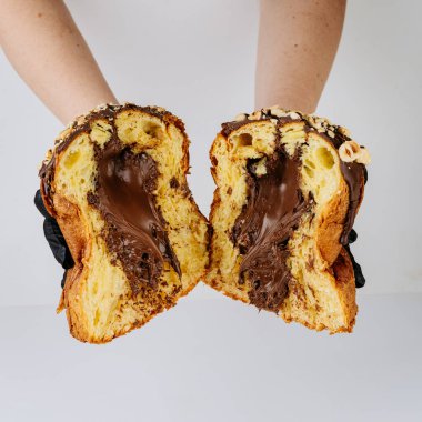 Ellerinde dilimlenmiş çikolatalı panettone, fırın hijyen konsepti. Yüksek kalite fotoğraf