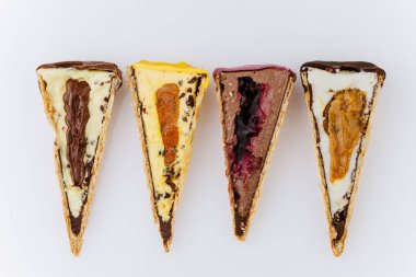 Renkli malzemeli dilimlenmiş dondurma külahları ve beyaz arka planda kremalı dolgu. Yüksek kalite fotoğraf