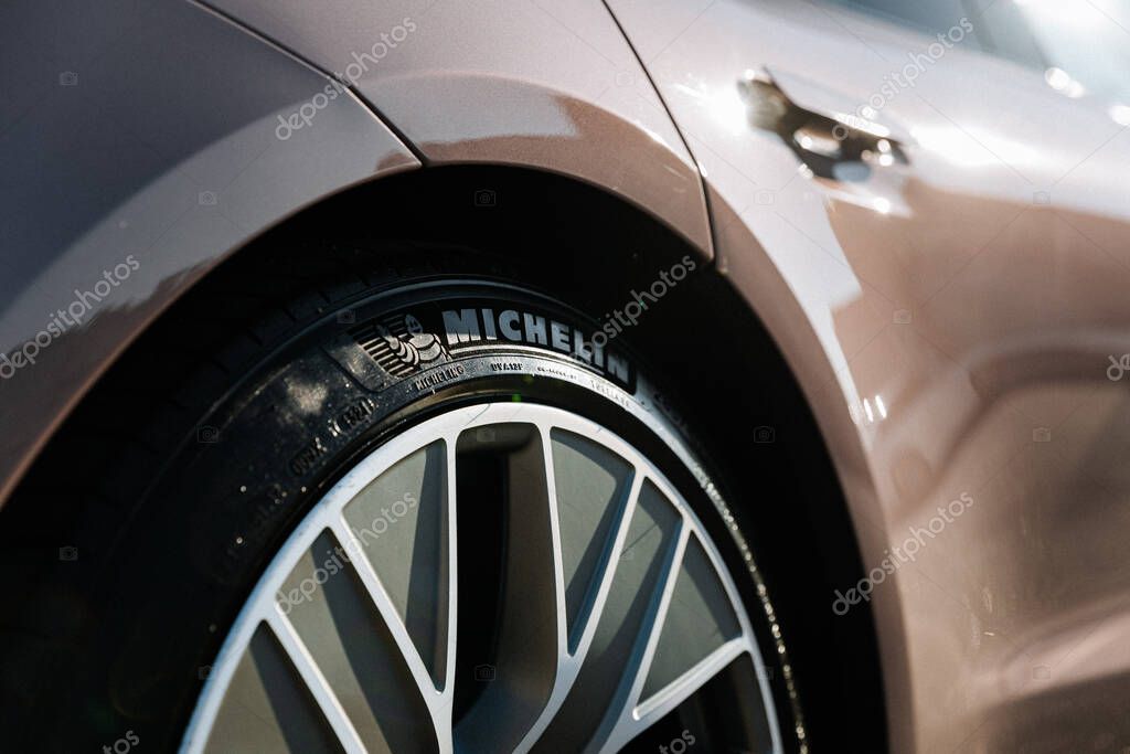 Vinnitsya, Ukraine - 15 of July 2025: Close-up of Michelin tire and wheel on pink Porsche Taycan. High quality photo