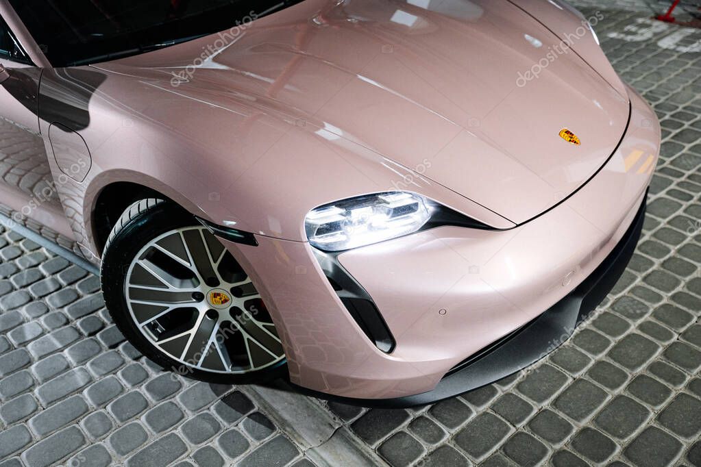 Vinnitsya, Ukraine-15 July 2025:Porsche Taycan front view with LED headlights in underground parking. High quality photo