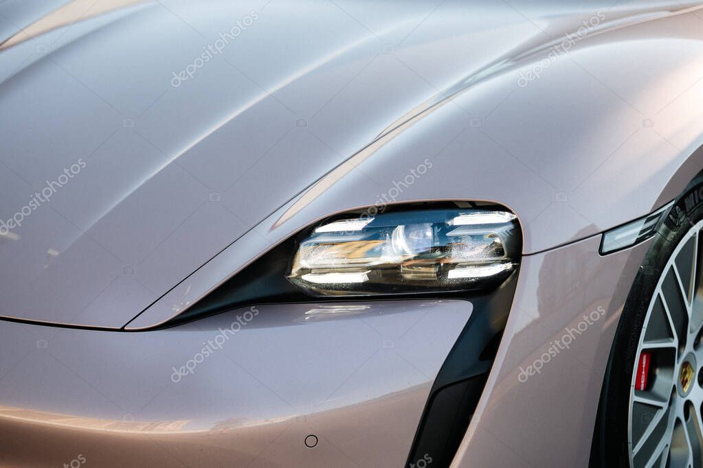 Vinnitsya, Ukraine - 15 of July 2025: Porsche Taycan LED headlight and hood close up in sunlight. High quality photo