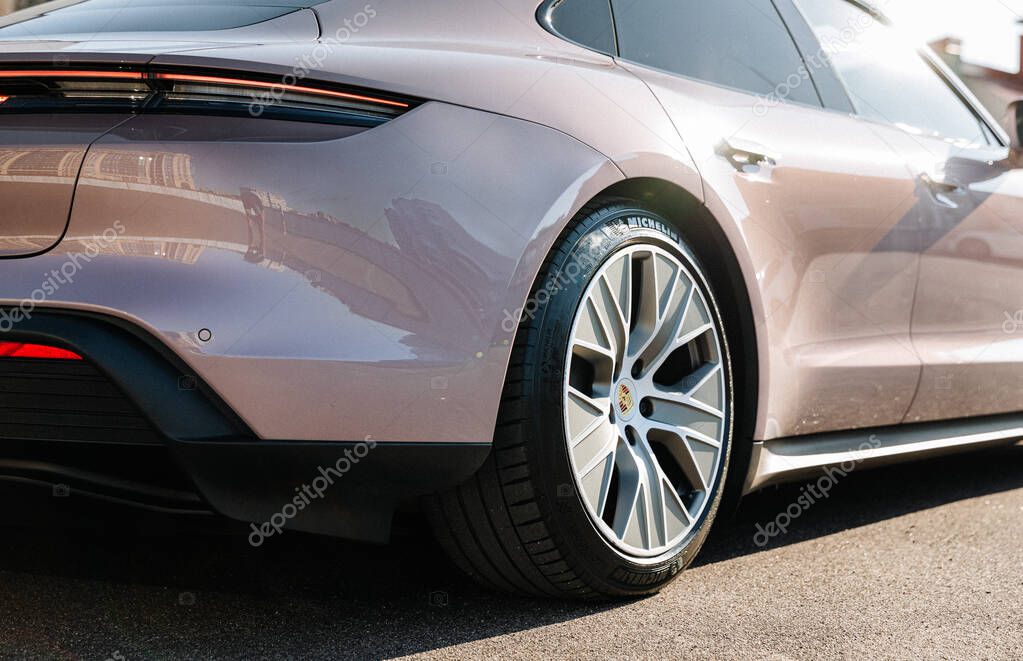 Vinnitsya, Ukraine - 15 of July 2025: Close up of pink Porsche Taycan rear wheel, tire . High quality photo