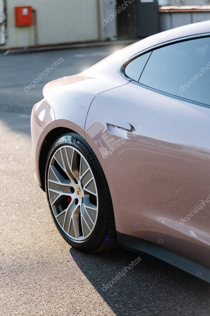 Vinnitsya, Ukraine - 15 of July 2025: Rear side of pink Porsche Taycan with alloy wheel in sunlight. High quality photo