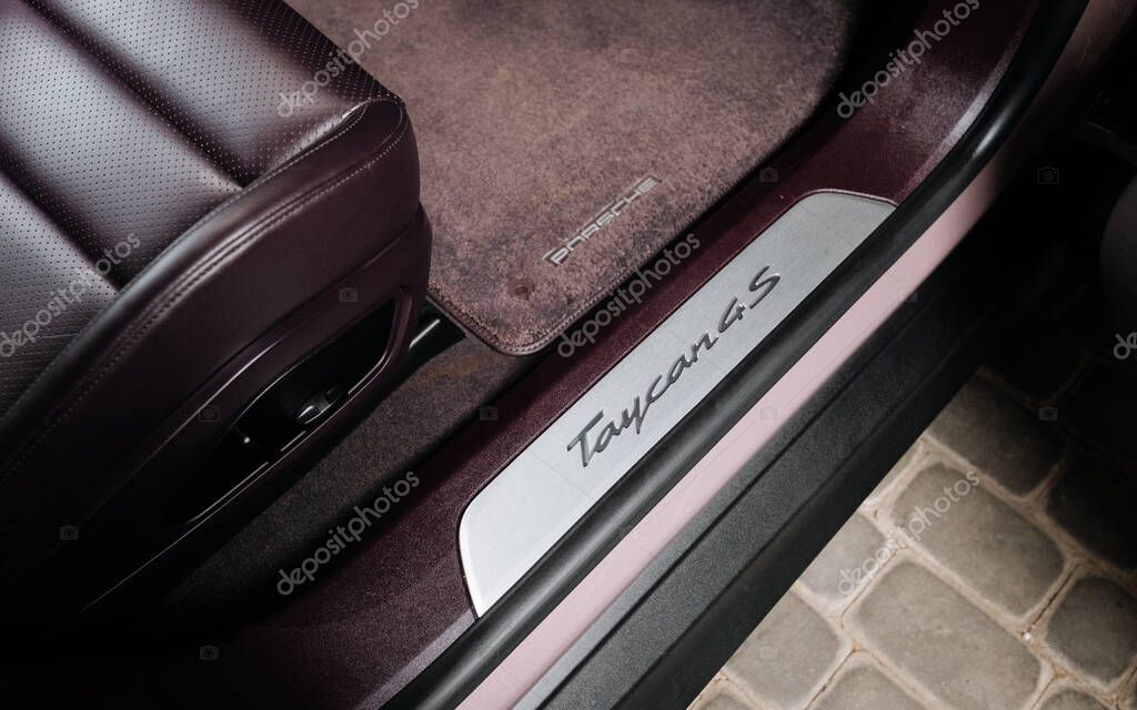 Vinnitsya, Ukraine - 15 July 2025: Porsche Taycan 4S illuminated door sill and leather seat detail. High quality photo