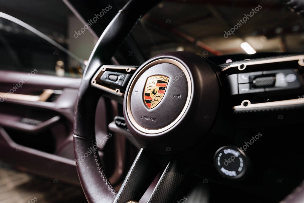 Vinnitsya, Ukraine - 15 of July 2025: Porsche Taycan steering wheel logo closeup inside luxury EV. High quality photo
