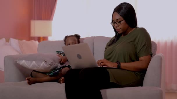 Afrikanische Mutter Arbeitet Mit Laptop Und Sitzt Sessel Während Das — Stockvideo