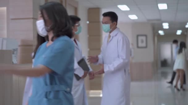 Hospital Busy Doctors Face Mask Talking While Standing Corridor Background — Stock Video