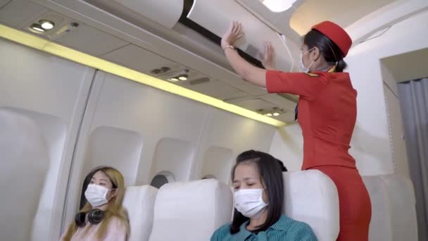 Passenger Sitting Airplane Woman Cabin Crew Face Mask Checking Airplane — Stock Video