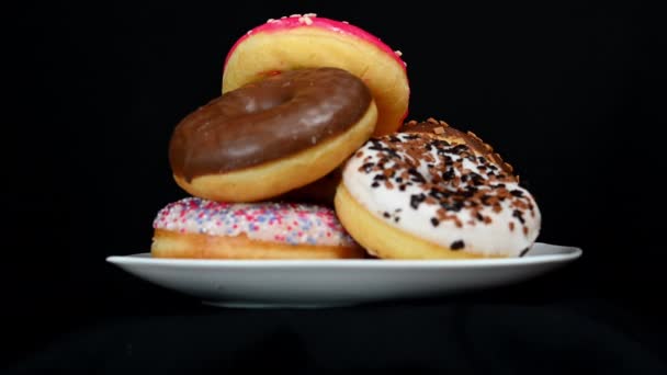 Rotating colorful donuts — Stock Video