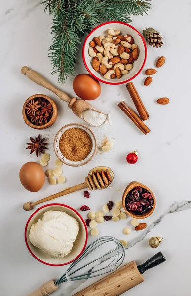 Christmas - baking cake background. Dough ingredients and decorations on white marble table. Kitchen layout with free text space. Top view. Flat lay