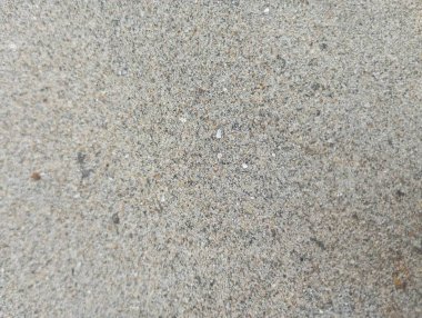 İnce renk değişiklikleriyle granüler beton yüzeyin büyüleyici soyut dokusu, arka plan ve tasarım projeleri için mükemmel..