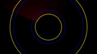 Hipnotik eşmerkezli daireler canlı kırmızı, yeşil ve mavi ile titreşiyor.