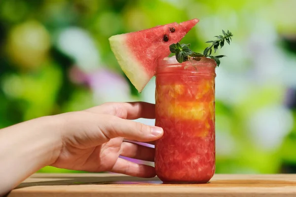 Female hand with watermelon drink.