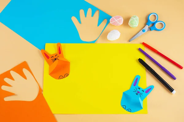 Colorful paper bunnies from childrens palm of their hand.