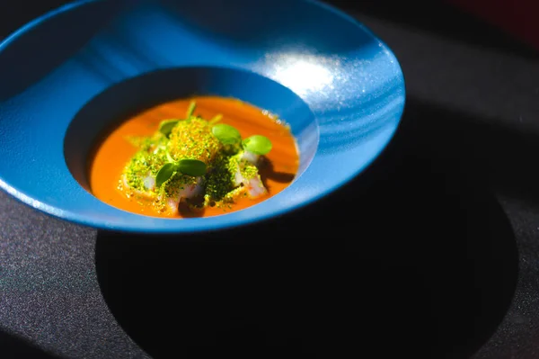 Luxurious seafood soup with caviar on a blue plate, in an expensive restaurant. — Stock Image Luxurious seafood soup with caviar on a blue plate, in an expensive restaurant. Royalty Free Stock Images