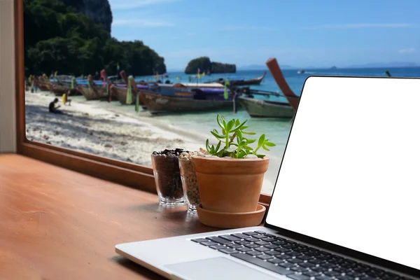 laptop on desk outdoor office and thai sea view blurred background. Laptop with blank screen and can be add your texts or others on Laptop. Laptop concept.selective focus.