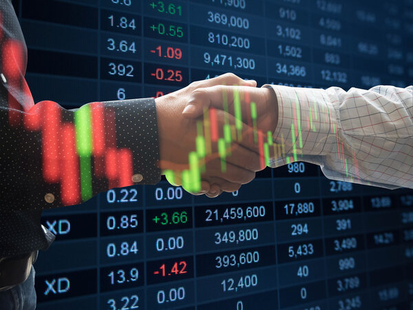 double exposure two cheerful business man handshaking and stock market chart and market data.