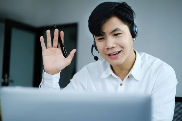 I have a question. Businessman raising their hands while online conference by laptop. Business and Entrepreneurship event.