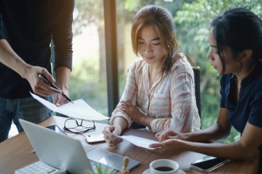 Ofis brifinginde beyin fırtınası. Girişim çalışmasında İş Kadınları Grubu analizi açıklıyor.