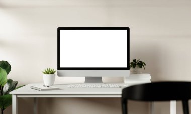 Modern bir çalışma alanı şık bir masaüstü monitörü, bitkileri ve minimalist tasarım elementlerini sergiliyor, üretkenlik için mükemmel..